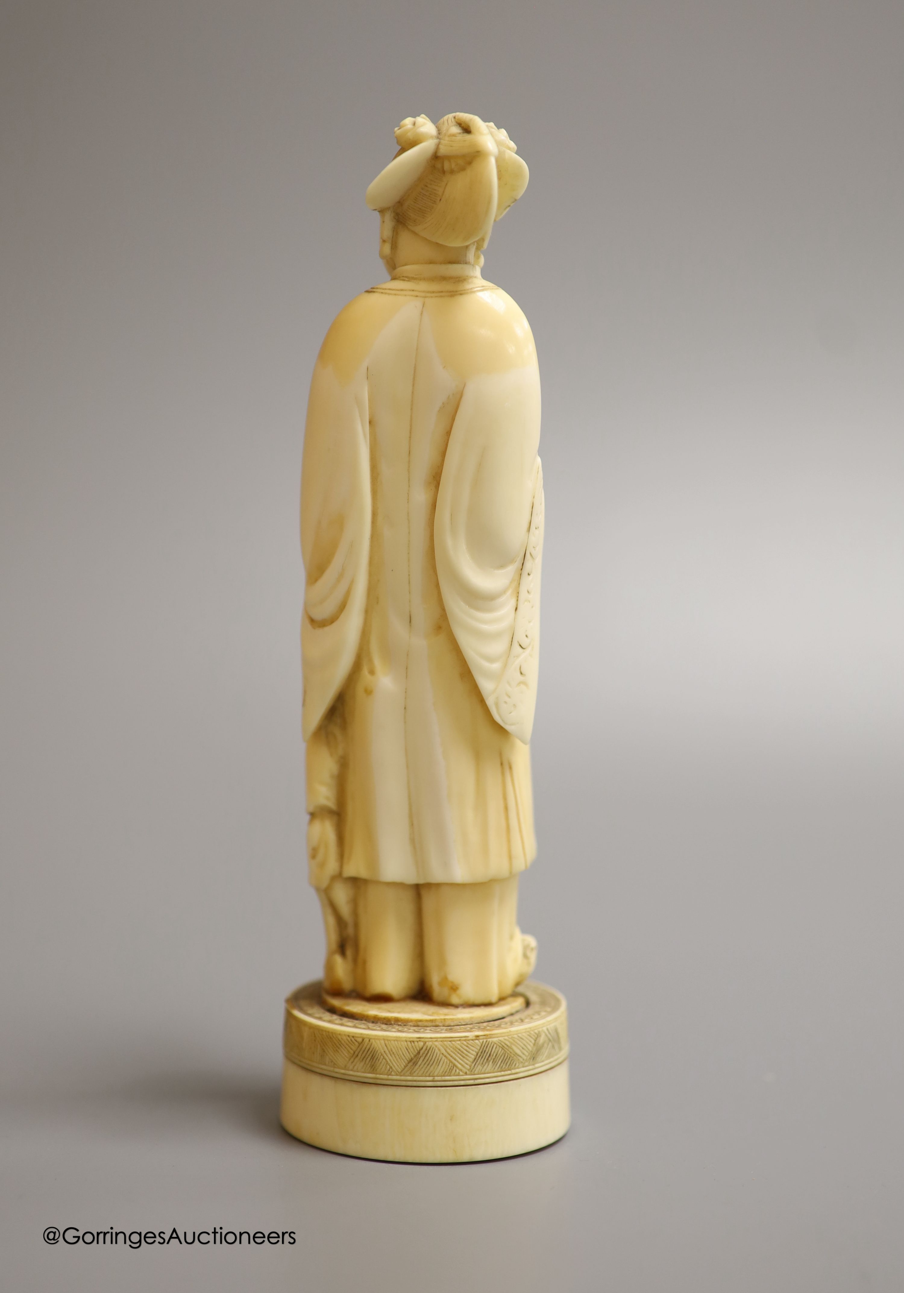 A Japanese ivory okimono of a lady feeding a child, Meiji period, height 18cm